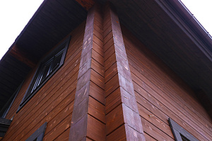 Комплекс работ по покраске деревянного дома с балками на террасе и стобами